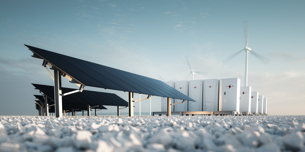 Image of solar panels, energy storage units and wind turbines to represent Microsoft sustainability.